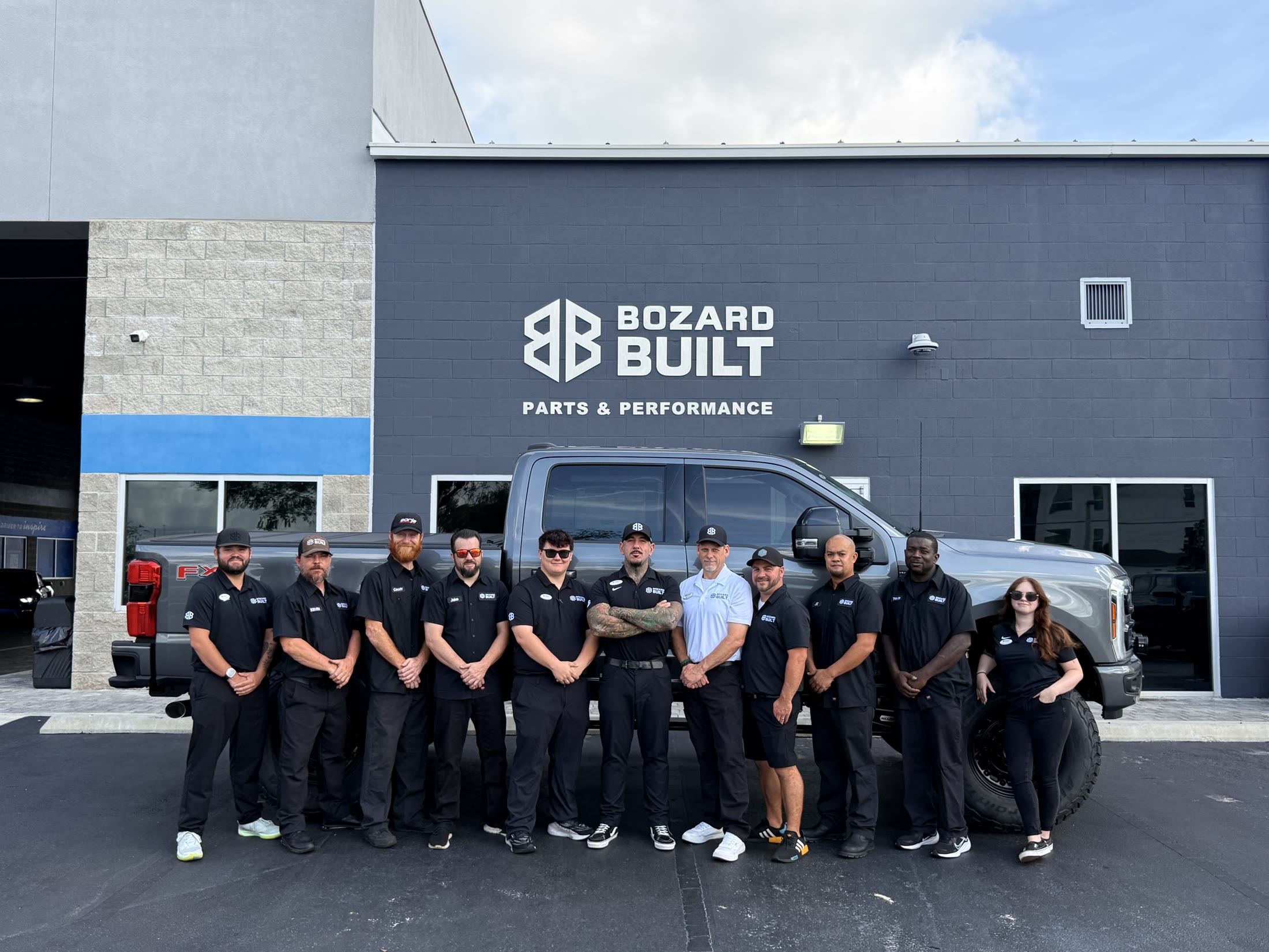 The Bozard Built crew in front of the shop with a lifted Super Duty